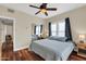 Bright bedroom with ceiling fan, hardwood floors, and mirrored closet at 1822 N 16Th Ave, Phoenix, AZ 85007