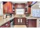 Well-lit kitchen with granite countertops, stainless steel appliances, and stained wood cabinets at 1822 N 16Th Ave, Phoenix, AZ 85007