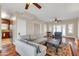 Open living room with hardwood floors and a stylish ceiling fan leading into a modernized kitchen at 1822 N 16Th Ave, Phoenix, AZ 85007