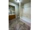 Clean bathroom featuring a shower-tub combination and wood vanity at 1870 N 128Th Dr, Avondale, AZ 85392