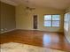 Well-lit living room with hardwood floors, ceiling fan, and neutral paint at 1870 N 128Th Dr, Avondale, AZ 85392