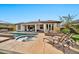 This backyard features a pool, spa, covered patio, built-in fireplace, and professional landscaping at 1918 W Medinah Ct, Anthem, AZ 85086