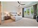 Bright bedroom featuring a king-size bed, patterned wallpaper, and large windows at 1918 W Medinah Ct, Anthem, AZ 85086