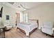 Cozy bedroom with wood floors, neutral colors, and two chairs at 1918 W Medinah Ct, Anthem, AZ 85086