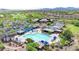 Aerial view of the large community pool with lap lanes, lounge chairs, and shaded seating areas at 1918 W Medinah Ct, Anthem, AZ 85086