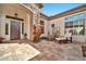 Private courtyard entrance with stone accents, potted plants, and seating area at 1918 W Medinah Ct, Anthem, AZ 85086