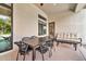 This covered patio features an outdoor dining table, seating, and a view of the landscaped yard at 1918 W Medinah Ct, Anthem, AZ 85086