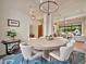 Elegant dining area with modern chandelier, round table, and comfortable seating at 1918 W Medinah Ct, Anthem, AZ 85086