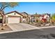 Charming single-story home with desert landscaping and stone accents on a sunny day at 1918 W Medinah Ct, Anthem, AZ 85086