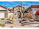 Landscaped front yard with desert plants, stone accents, and a modern exterior at 1918 W Medinah Ct, Anthem, AZ 85086