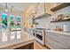 Bright, open kitchen featuring granite countertops, professional-grade range, and custom cabinetry at 1918 W Medinah Ct, Anthem, AZ 85086