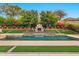 Beautiful backyard pool featuring a stone waterfall, fireplace, and lush greenery at 1918 W Medinah Ct, Anthem, AZ 85086