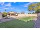 Wide angle showing a large, well-manicured backyard with a swimming pool and putting green at 2019 E Wahalla Ln, Phoenix, AZ 85024