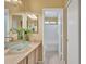 Bathroom vanity area with a glass sink, large mirror, and linen closet at 2019 E Wahalla Ln, Phoenix, AZ 85024