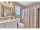 Bathroom features a white vanity, neutral shower curtain and bright natural light at 2019 E Wahalla Ln, Phoenix, AZ 85024