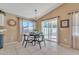 Bright dining area features a modern light fixture, neutral decor, and sliding door access to backyard at 2019 E Wahalla Ln, Phoenix, AZ 85024