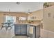 Open-concept kitchen island with a sink and dishwasher, seamlessly connecting to the dining and living areas at 2019 E Wahalla Ln, Phoenix, AZ 85024