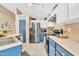 Well-lit kitchen with white cabinetry, stainless steel appliances, and an adjacent dining area and pantry at 2019 E Wahalla Ln, Phoenix, AZ 85024