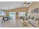 Bright living room with vaulted ceilings, a ceiling fan, neutral furniture, and access to the backyard at 2019 E Wahalla Ln, Phoenix, AZ 85024