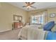 Bright main bedroom featuring a ceiling fan, backyard view, dresser, and carpet flooring at 2019 E Wahalla Ln, Phoenix, AZ 85024