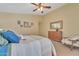 Relaxing main bedroom boasts a ceiling fan, a dresser, a mirror, and neutral carpet at 2019 E Wahalla Ln, Phoenix, AZ 85024