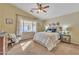 Cozy main bedroom with a ceiling fan, a large window, and neutral decor at 2019 E Wahalla Ln, Phoenix, AZ 85024