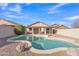 A large pool surrounded by desert landscaping with covered patio in the background at 2019 E Wahalla Ln, Phoenix, AZ 85024