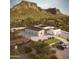 Luxury home nestled against a mountain, featuring modern architecture and desert landscaping at 2075 N Holmes Rd, Apache Junction, AZ 85119