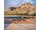 Scenic pool with mountain views and desert landscaping perfect for relaxing or entertaining guests at 2075 N Holmes Rd, Apache Junction, AZ 85119