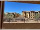 Scenic view from the home overlooking neighboring tan apartment buildings and desert landscaping at 21208 N 58Th St, Phoenix, AZ 85054