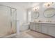 Bright bathroom featuring a glass shower, a soaking tub, and dual sinks with large mirrors at 22864 E Via Del Sol --, Queen Creek, AZ 85142