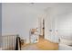 Bright bedroom with wood flooring, natural light, and white storage shelves at 22864 E Via Del Sol --, Queen Creek, AZ 85142