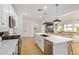 Modern kitchen featuring white cabinets, an island with seating, and stainless steel appliances at 22864 E Via Del Sol --, Queen Creek, AZ 85142