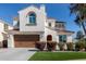 Charming two-story home featuring a red tile roof, white stucco, arched entry, and landscaped front yard at 2300 W Sunrise Pl, Chandler, AZ 85248