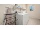 Bright laundry room features a new washer and dryer with convenient shelving at 2300 W Sunrise Pl, Chandler, AZ 85248