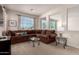 Comfortable living room featuring large brown sofa and glass coffee tables under natural light at 2300 W Sunrise Pl, Chandler, AZ 85248