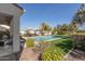 Tranquil backyard featuring a sparkling pool, well-manicured lawn, lounge chairs, and shade trees at 2300 W Sunrise Pl, Chandler, AZ 85248