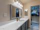 Bathroom featuring dual sinks, modern lighting, and a spacious countertop at 233 N 21St St, Coolidge, AZ 85128