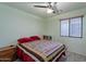 Bedroom with wood-look floors, ceiling fan, closet, and window, ready for personalization at 233 N 21St St, Coolidge, AZ 85128