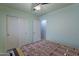 Bedroom with wood-look floors, neutral walls, a ceiling fan, and closet space for comfortable living at 233 N 21St St, Coolidge, AZ 85128