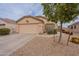 Charming single-story home with low-maintenance desert landscaping and an attached two-car garage at 233 N 21St St, Coolidge, AZ 85128