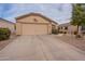 Charming single-story home with low-maintenance desert landscaping and an attached two-car garage at 233 N 21St St, Coolidge, AZ 85128