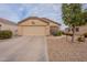 Charming single-story home with low-maintenance desert landscaping and an attached two-car garage at 233 N 21St St, Coolidge, AZ 85128