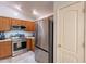 Kitchen featuring stainless steel appliances, a refrigerator, and wood cabinets at 233 N 21St St, Coolidge, AZ 85128