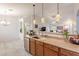 Bright kitchen with modern appliances, island sink, and decorative pendant lighting at 233 N 21St St, Coolidge, AZ 85128