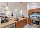 Bright kitchen featuring wood cabinets, stainless steel appliances, and open design to the living area at 233 N 21St St, Coolidge, AZ 85128