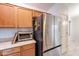 Kitchen with stainless steel refrigerator and wood cabinetry at 233 N 21St St, Coolidge, AZ 85128