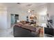 Spacious living room with tile floors, ceiling fan, and views into kitchen and other living spaces at 233 N 21St St, Coolidge, AZ 85128