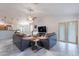 Open-concept living room with tile floors, sectional sofa, ceiling fan, and sliding glass door at 233 N 21St St, Coolidge, AZ 85128