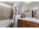 Bathroom featuring a tub with tiled walls, neutral colors, and a vanity with decorative items at 24027 N 164Th Dr, Surprise, AZ 85387